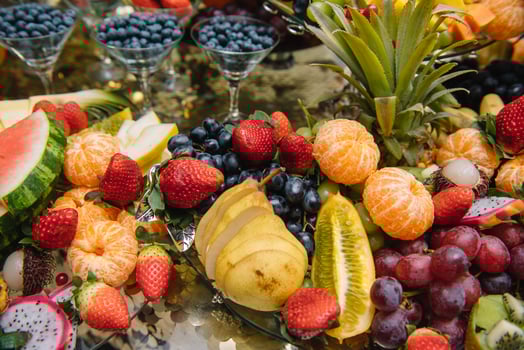 Fresh organic fruits background. Healthy eating concept. Fresh, exotic, organic fruits, light snacks in a plate on a buffet table photo