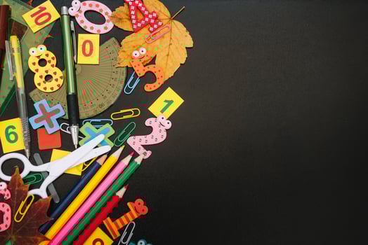 Back to school concept. School and office supplies on blackboard background. Flat lay with copy space photo