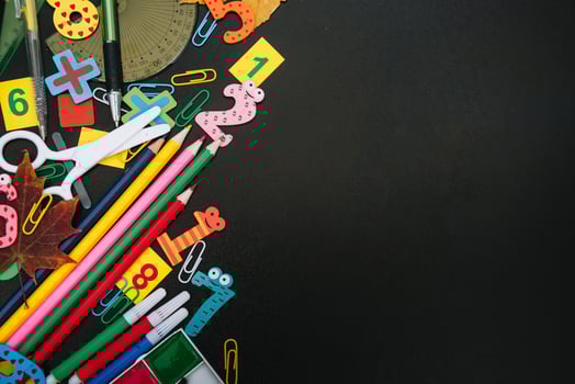 Back to school concept. School and office supplies on blackboard background. Flat lay with copy space photo