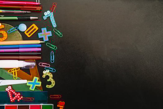 Back to school concept. School and office supplies on blackboard background. Flat lay with copy space photo