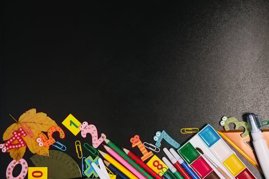 Back to school concept. School and office supplies on blackboard background. Flat lay with copy space photo