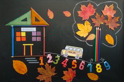 Back to school concept. School and office supplies on blackboard background photo