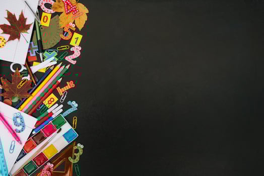 Back to school concept. School and office supplies on blackboard background. Flat lay with copy space photo