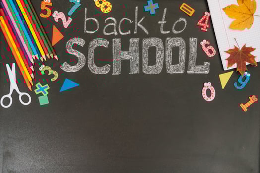 Back to school concept. School and office supplies on blackboard background. Flat lay with copy space photo