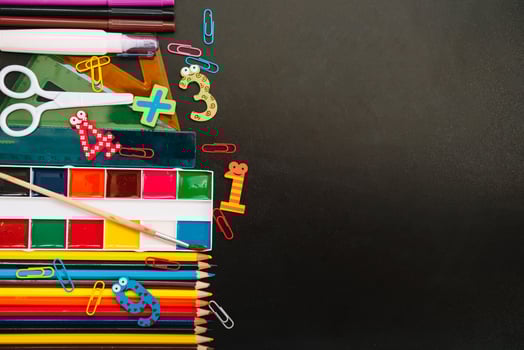 Back to school concept. School and office supplies on blackboard background. Flat lay with copy space photo