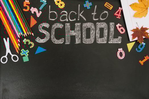 Back to school concept. School and office supplies on blackboard background. Flat lay with copy space photo