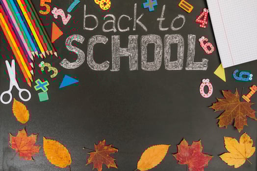 Back to school concept. School and office supplies on blackboard background. Flat lay with copy space photo