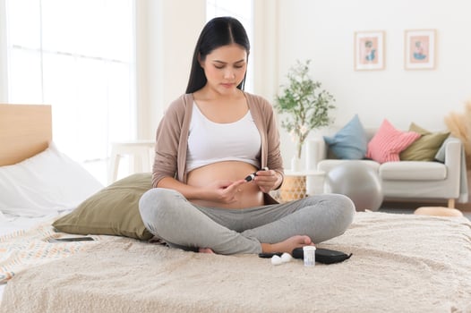Pregnant woman checking blood sugar level by using Digital Glucose meter, health care, medicine, diabetes, glycemia concept photo