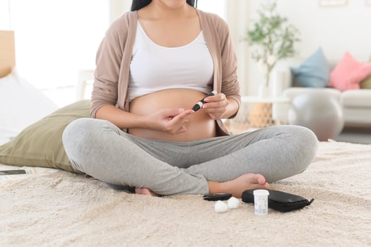 Pregnant woman checking blood sugar level by using Digital Glucose meter, health care, medicine, diabetes, glycemia concept photo