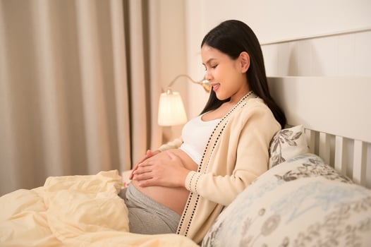Beautiful pregnant woman applying moisturizing, stretch mark cream on belly, fertility infertility treatment, IVF, future maternity concept photo