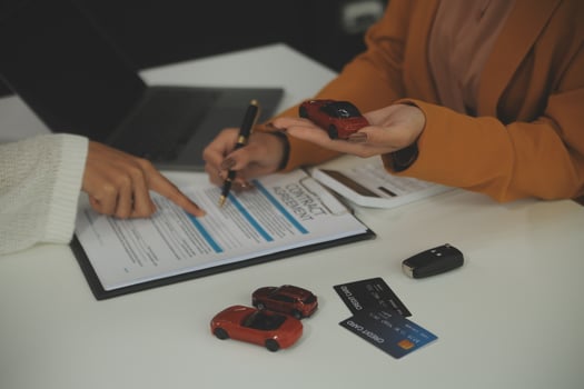 Insurance officers hand over the car keys after the tenant. have signed an auto insurance document or a lease or agreement document Buying or selling a new or used car with a car photo
