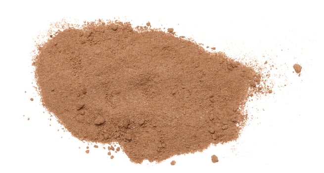 Dry ground cocoa powder scattered on an isolated background photo