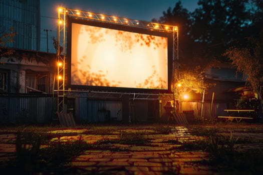 blank white screen outdoors in green grass park. outdoor cinema, big screen show. photo