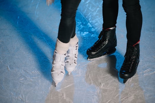 Romantic couple on date. Young couple standing together outdoors on open ice rink in snowy winter landscape photo