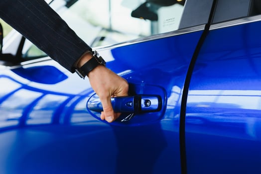 Male hand on the shift lever of the transmission in the car photo