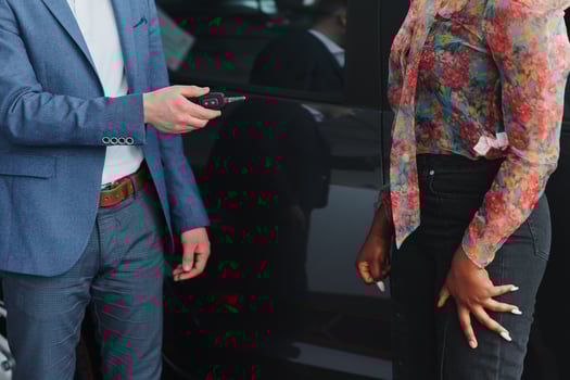 beautiful young african woman buying a car at dealership photo
