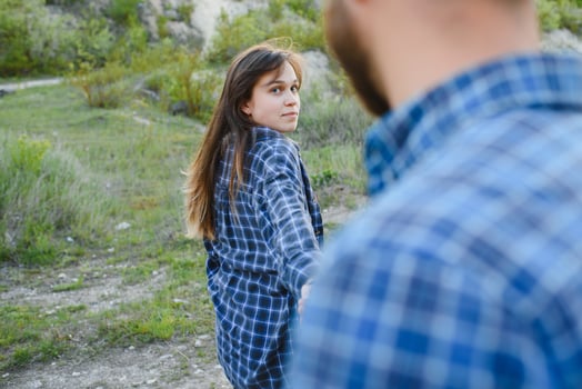 Couple in love rest on green hill in country side photo