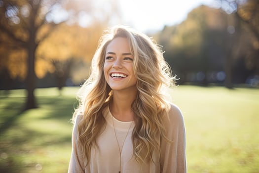 Young blonde woman smiling at the park photo