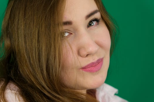 Portrait of a beautiful girl on a green background photo