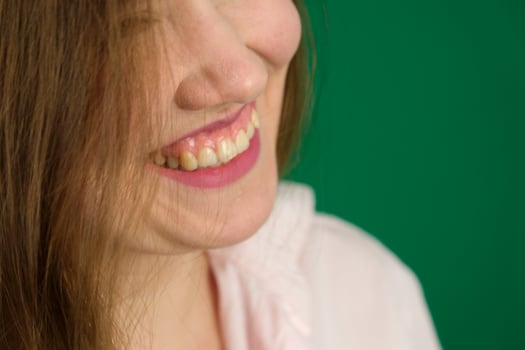 Close up female beauty portrait with Light make-up and clean skin. Young woman smiling and looking aside. photo