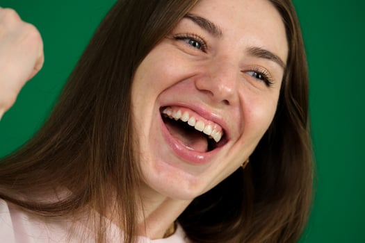 A pretty women throws her head back in a big laugh. photo