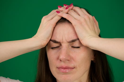 Portrait of a young woman has a headache, migraine, closeup photo