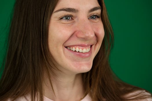 Beautiful and happy woman laughing over a green background photo
