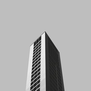 Minimalist architectural photography of a modern building with black and white facade, contrasting shapes, and perspective. Ideal for urban design themes and structural engineering concepts. photo