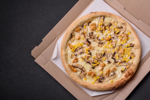 Delicious pizza with corn, cheese, tomatoes and mushrooms, salt, spices and herbs photo