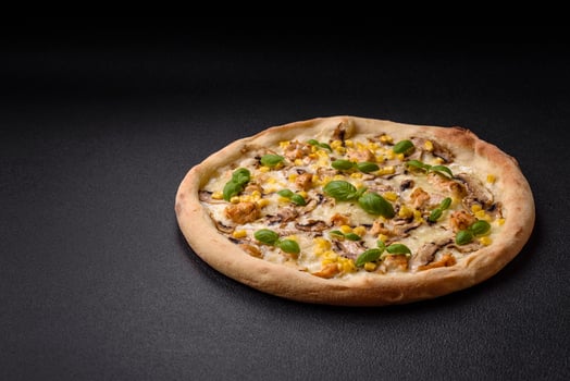 Delicious pizza with corn, cheese, tomatoes and mushrooms, salt, spices and herbs photo
