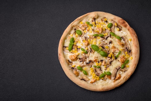 Delicious pizza with corn, cheese, tomatoes and mushrooms, salt, spices and herbs photo