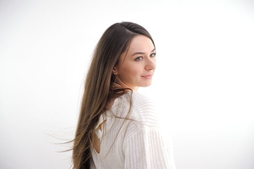 Portrait of glamorous young sexy woman wearing blue jeans on white photo