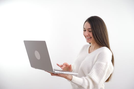 banner girl with laptop in headphones communicates online conference with friends waving a lot of space for text ad gadgets online courses internet social networks Web studio woman beautiful teeth photo