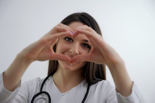 Smiling young girl showing heart with two hands, love sign Isolated over light blue background Portrait young beautiful woman hand gesturing in heart shape Smile face girl get in love photo