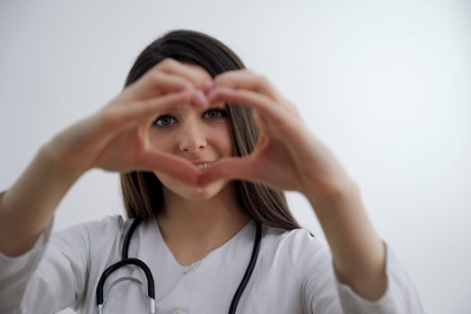 girl showing heart with her hands young young doctor looking through hands helping close relatives and good people Hippocratic oath help care medical secret love treatment cardiology heart hospital photo