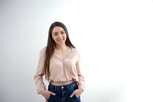 Portrait of an elegant young woman in white top and black pants in the studio. photo