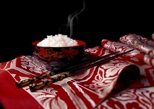 hot Japanese rice in bowl on fabric photo