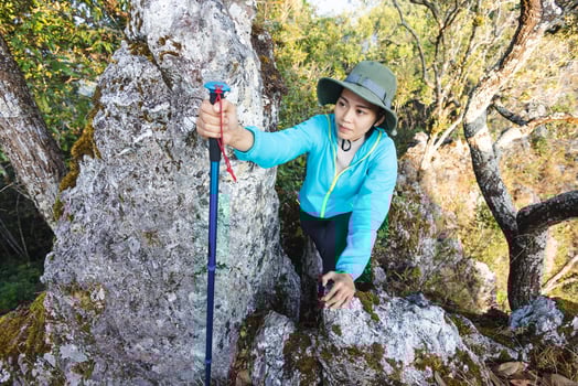 Person women hikers living healthy active lifestyle on a mountain with steep and rocky slopes. photo