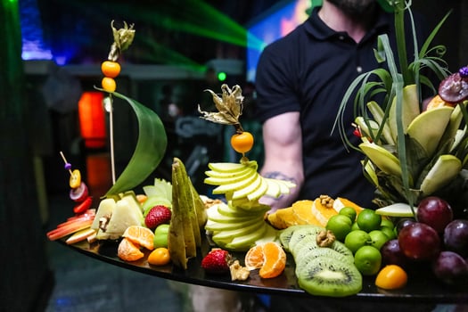 Man Standing in Front of Fruit Tray at Market photo