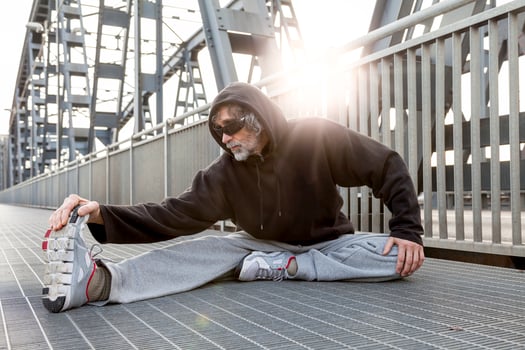 athlete doing stretching on metal bridge. Healthy lifestyle and sport concept photo
