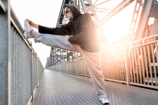 athlete doing stretching on metal bridge. Healthy lifestyle and sport concept photo