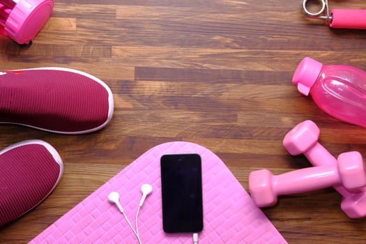smart phone with earphone dumbbell, shoe and exercise mat floor photo