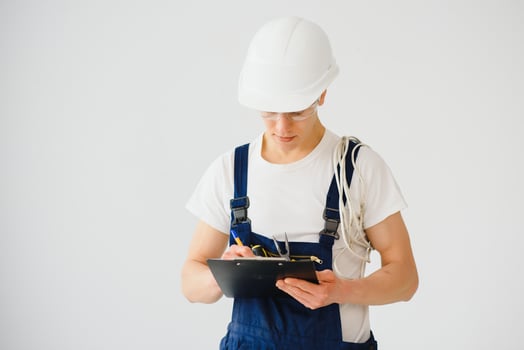 handsome electrical engineer holding clipboard on white background photo