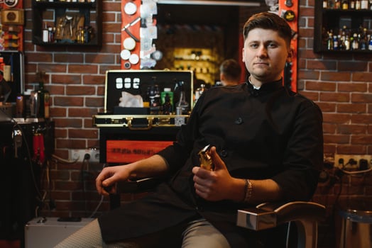 Hairdresser. Salon for men. Barbershop concept. Handsome man with barber tools. Professional beard and hair care. photo