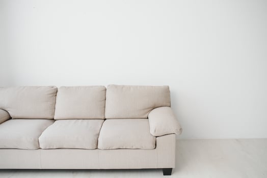 Grey comfortable sofa against white wall in the room photo