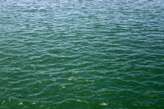 The color of water in the Mediterranean Sea in shallow water. Natural abstract background. photo