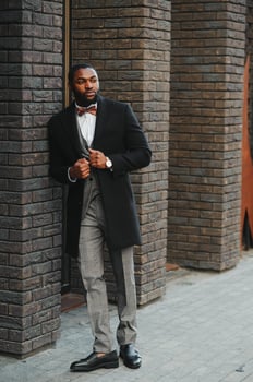 Portrait of an African American businessman wearing a suit standing in an outdoor business environment photo