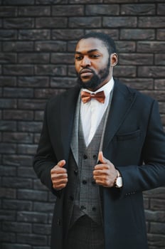 Portrait of an African American businessman wearing a suit standing in an outdoor business environment photo