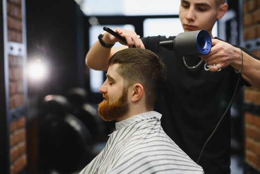 Close-up, master hairdresser does hairstyle and style with scissors and comb. Concept Barbershop photo