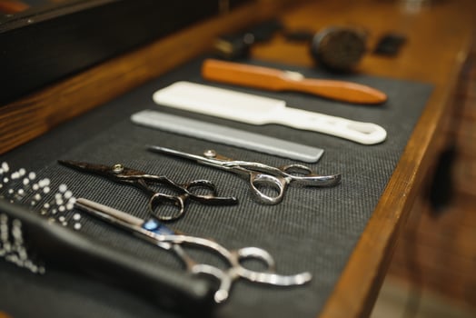 Vintage barber shop tools on old wooden background photo